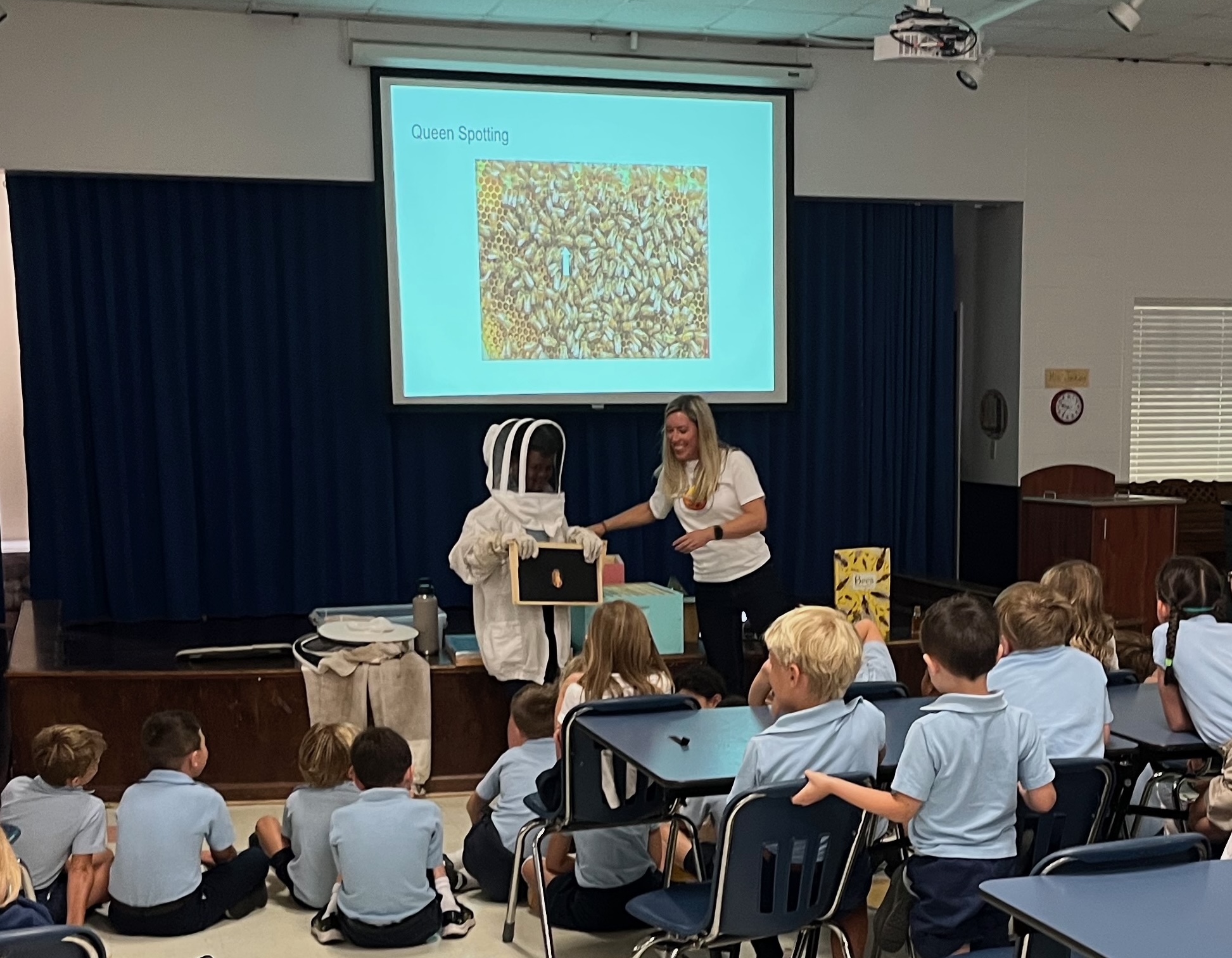 Molly presenting hive materials to a classroom of students